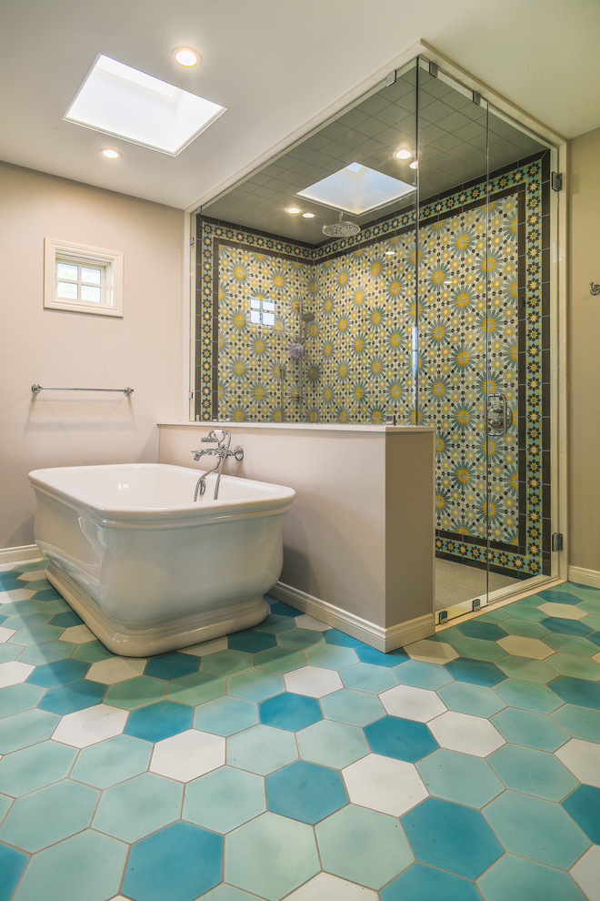 Photo of a mid-sized transitional master bathroom in San Diego with a freestanding tub, a curbless shower, green tile, cement tile, grey walls, cement tiles, blue floor and a hinged shower door.