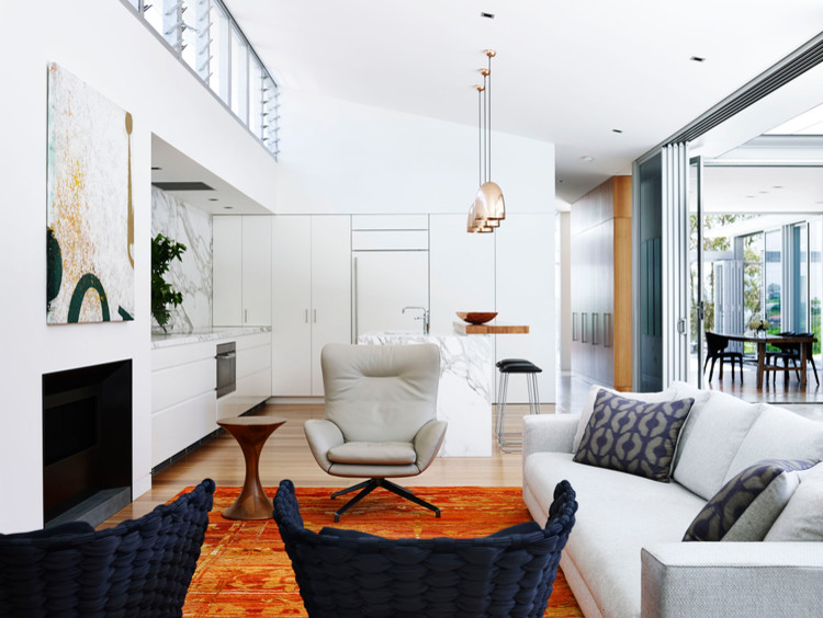 Inspiration for a large contemporary open concept family room in Melbourne with white walls, light hardwood floors, a standard fireplace and a plaster fireplace surround.