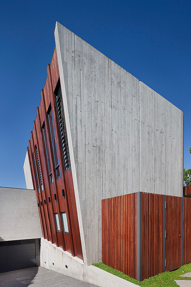 Large contemporary three-storey concrete exterior in Melbourne with a flat roof.