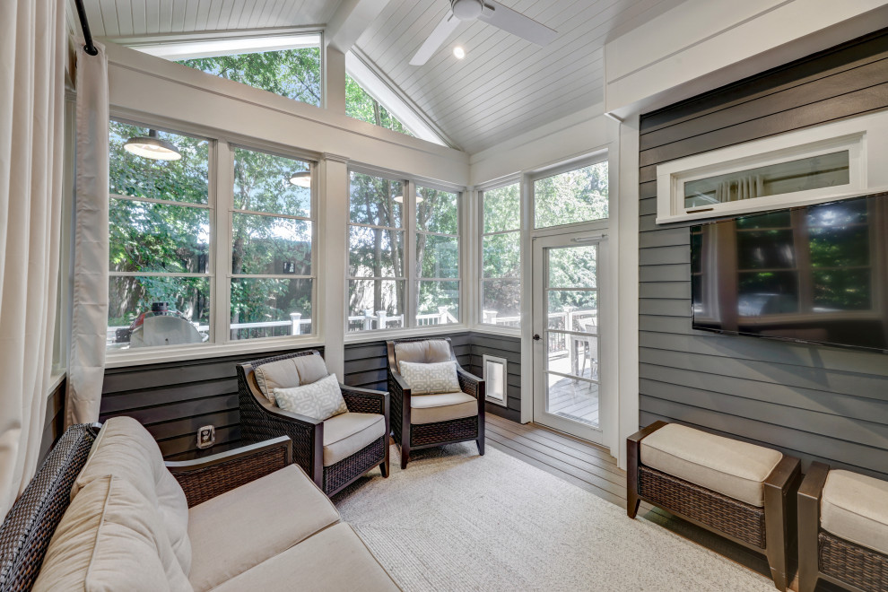 This is an example of a small conservatory in Atlanta with brown floors.