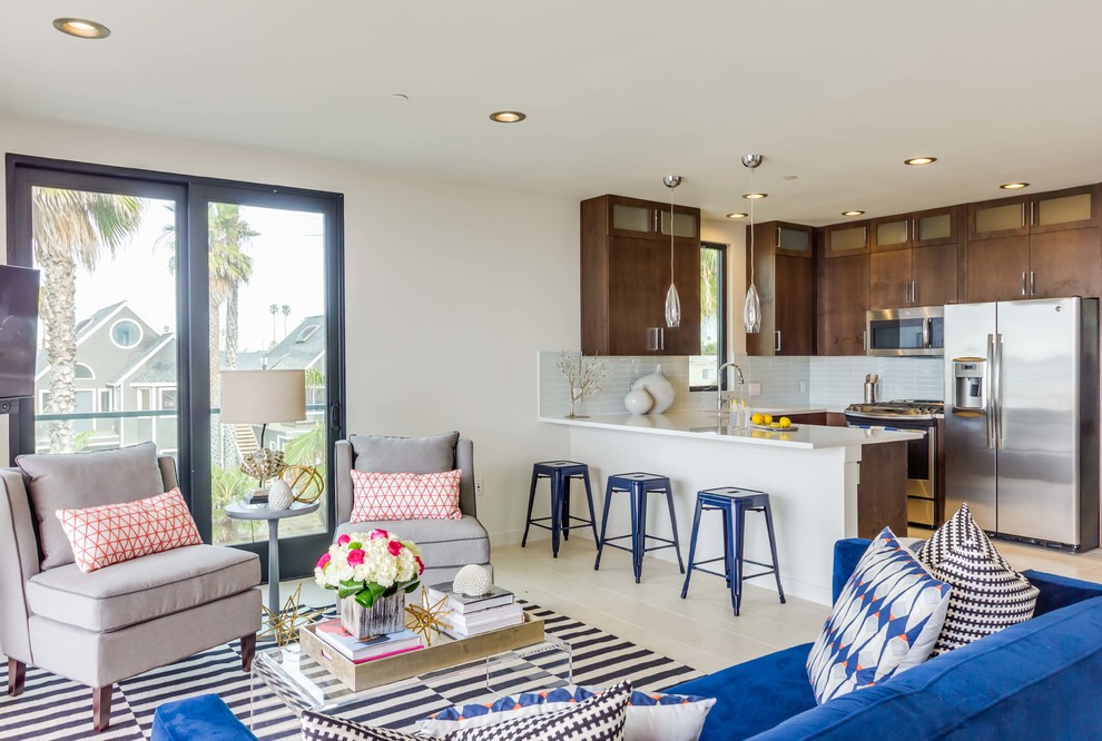 Inspiration for a mid-sized beach style open concept living room in San Diego with white walls, porcelain floors, white floor and a freestanding tv.
