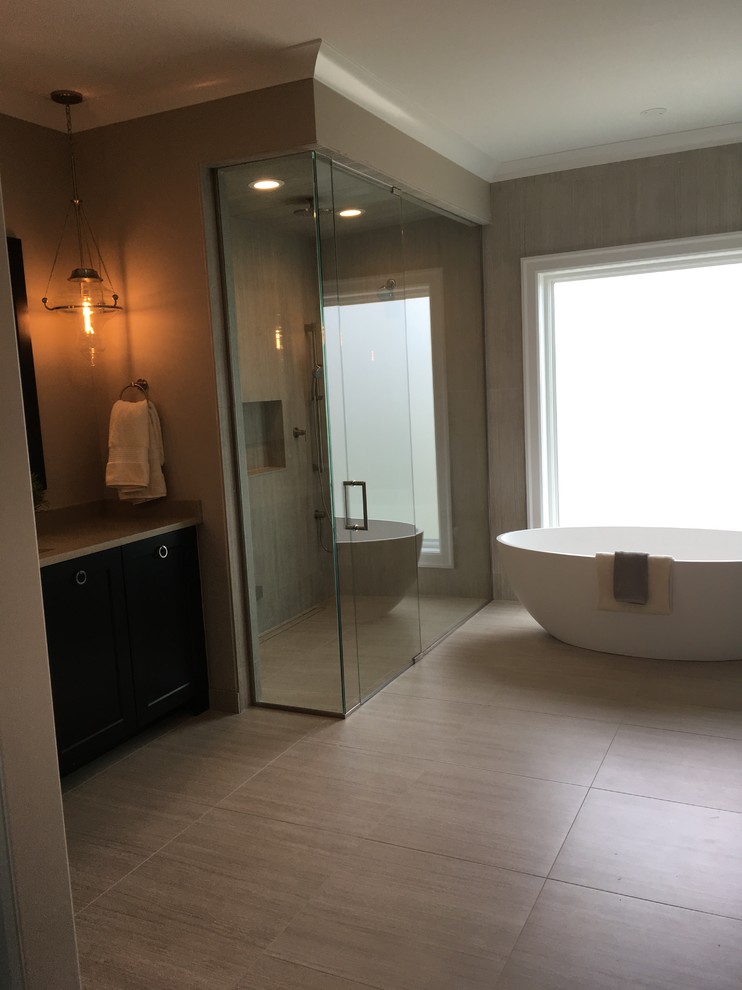 Example of a large transitional master beige tile and porcelain tile porcelain tile and beige floor home design design in Chicago with shaker cabinets, dark wood cabinets, a two-piece toilet, brown walls, an undermount sink, quartz countertops, a hinged shower door and beige countertops