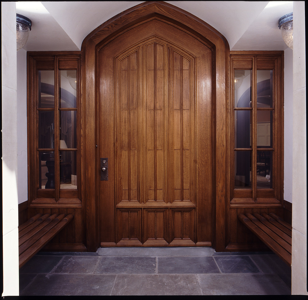 Inspiration for a large traditional front door in New York with white walls, slate floors, a single front door and a medium wood front door.