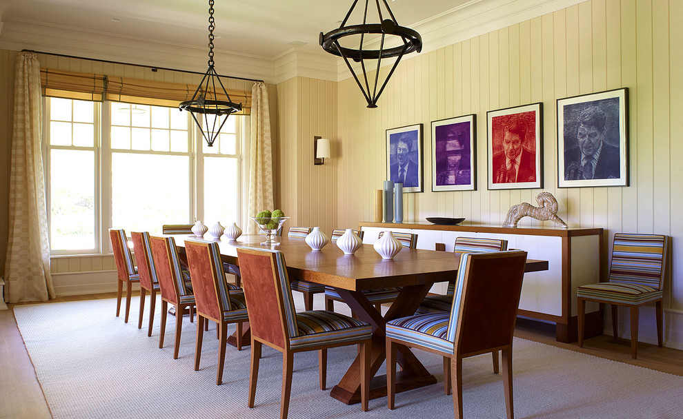 Inspiration for a large country dining room in New York with yellow walls and light hardwood floors.