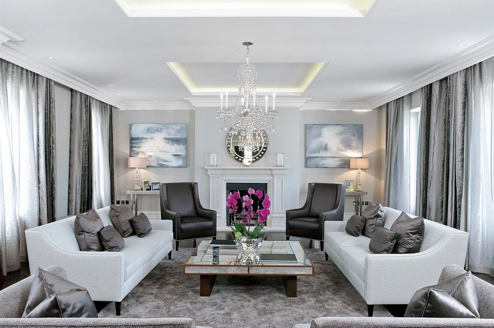 Photo of a large transitional formal living room in London with grey walls and a standard fireplace.