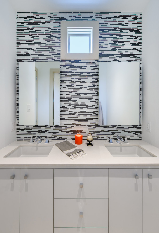 This is an example of a contemporary bathroom in Dallas with an undermount sink, flat-panel cabinets, white cabinets, multi-coloured tile and matchstick tile.
