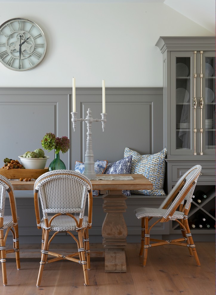 Dining room - coastal medium tone wood floor dining room idea in Boston with white walls