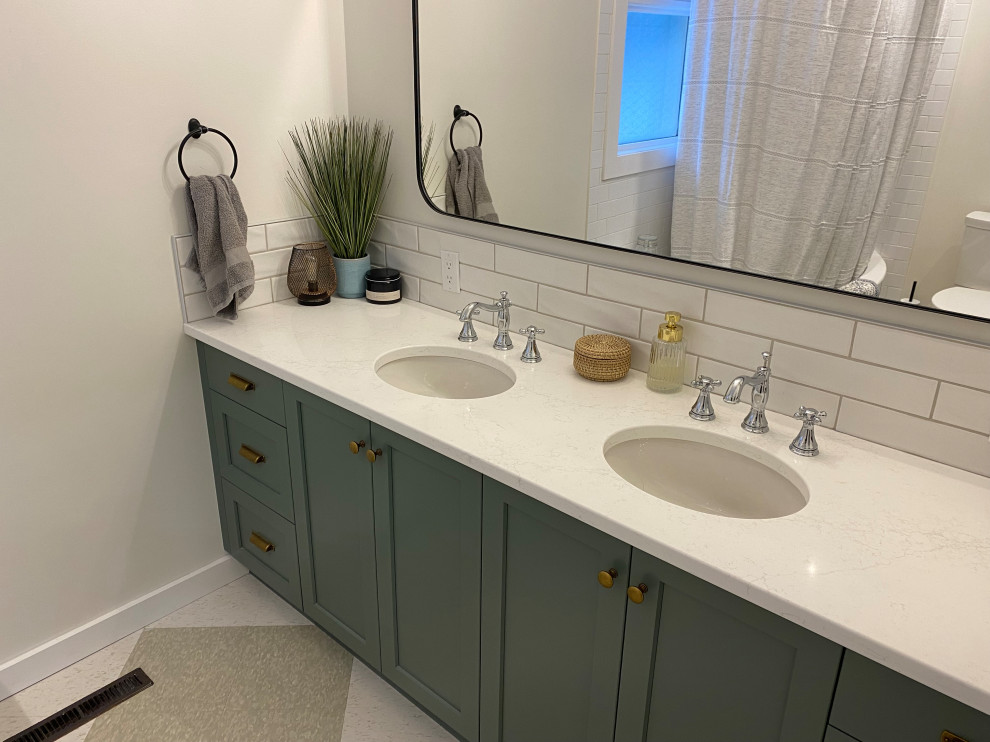 This is an example of a mid-sized transitional 3/4 bathroom in Other with shaker cabinets, green cabinets, a one-piece toilet, white tile, ceramic tile, white walls, linoleum floors, an undermount sink, white floor, a shower curtain, white benchtops, a double vanity and a built-in vanity.