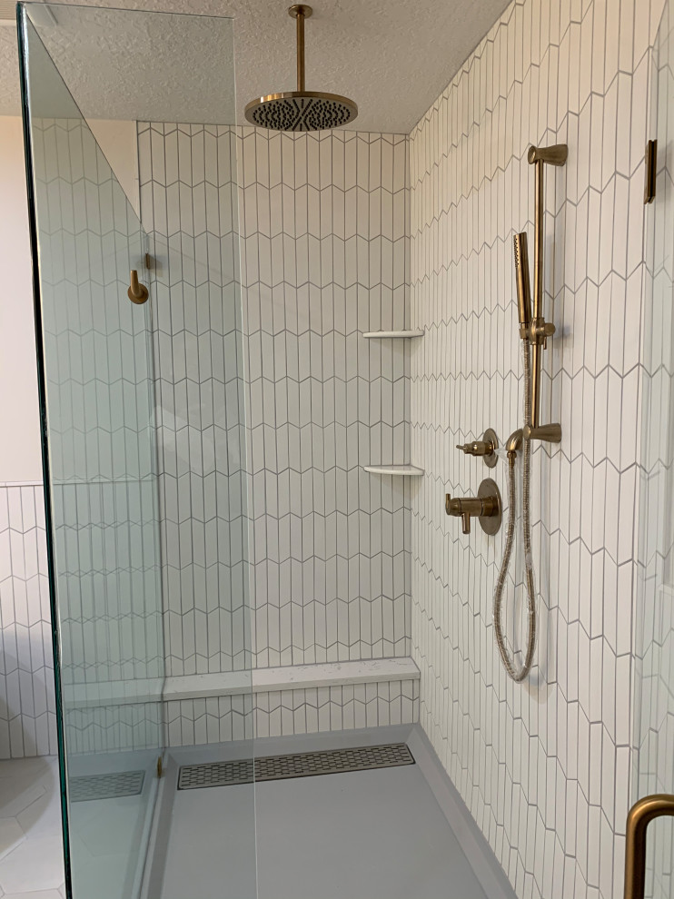 Photo of a mid-sized midcentury master bathroom in Albuquerque with furniture-like cabinets, medium wood cabinets, a freestanding tub, a corner shower, a two-piece toilet, white tile, mosaic tile, white walls, porcelain floors, an undermount sink, quartzite benchtops, grey floor, a hinged shower door, white benchtops, a double vanity, a freestanding vanity, exposed beam and decorative wall panelling.