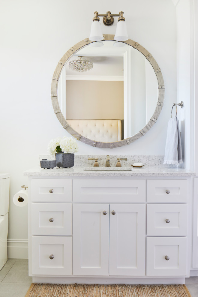 Inspiration for a large transitional master bathroom in Other with shaker cabinets, white cabinets, an open shower, a one-piece toilet, white tile, porcelain tile, white walls, porcelain floors, an undermount sink, solid surface benchtops, beige floor, a sliding shower screen, grey benchtops, a single vanity and a built-in vanity.