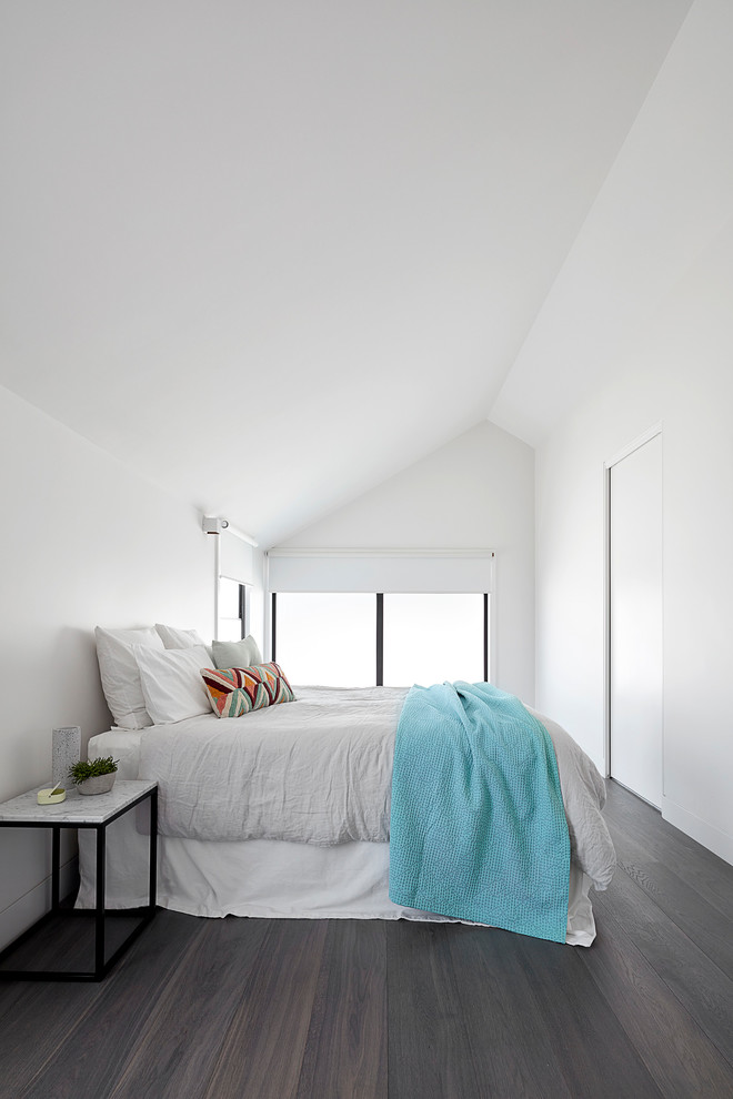 This is an example of a mid-sized contemporary master bedroom in Melbourne with white walls, medium hardwood floors and grey floor.
