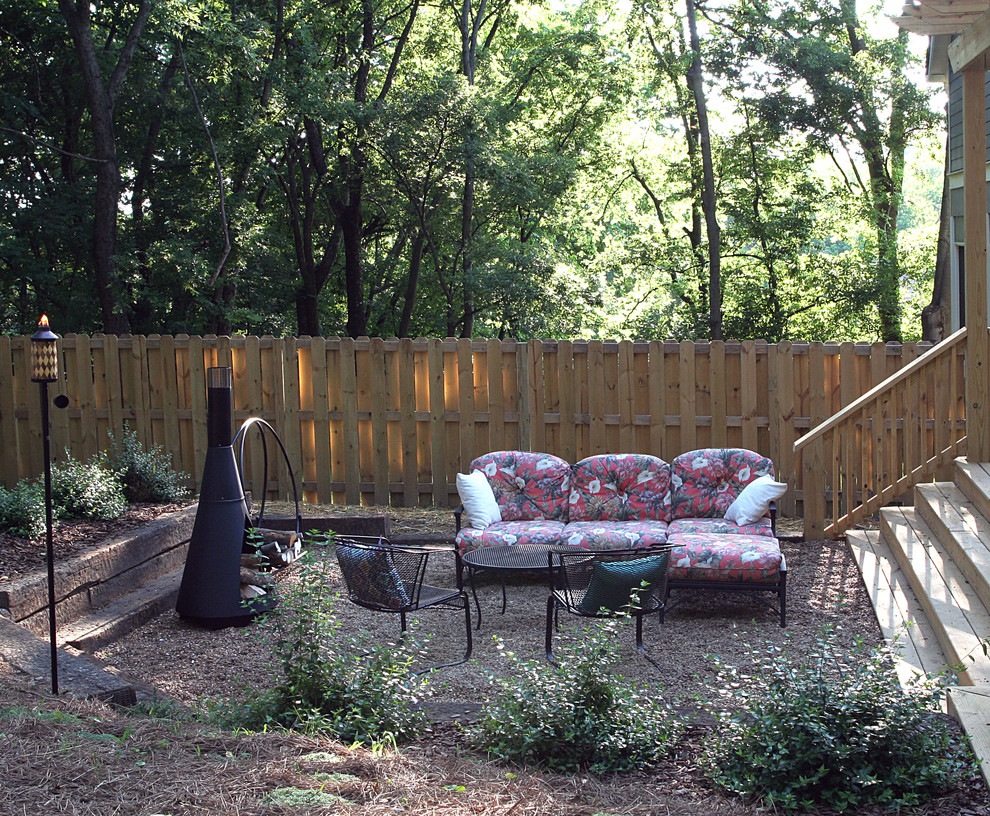 Design ideas for a mid-sized country backyard partial sun garden for fall in Nashville with gravel.