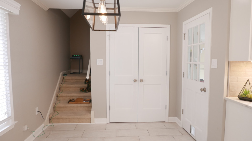 Eat-in kitchen - mid-sized transitional galley porcelain tile and beige floor eat-in kitchen idea with an undermount sink, shaker cabinets, white cabinets, quartz countertops, brown backsplash, porcelain backsplash, stainless steel appliances, no island and white countertops