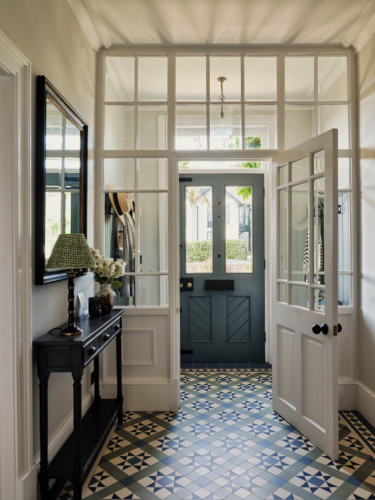 Inspiration for a large classic vestibule in Other with grey walls, ceramic flooring, a single front door, a blue front door, multi-coloured floors and panelled walls.