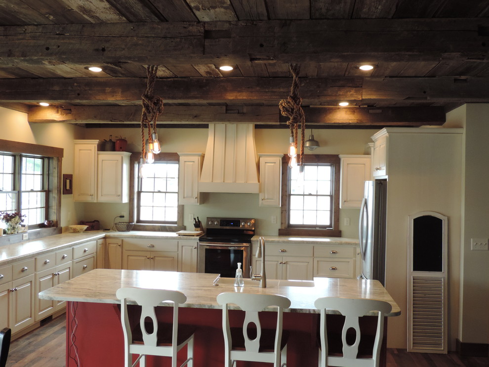Large mountain style u-shaped dark wood floor eat-in kitchen photo with a farmhouse sink, raised-panel cabinets, white cabinets, marble countertops, stainless steel appliances and an island