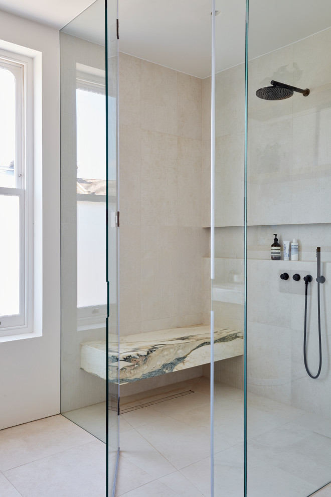 This is an example of a contemporary 3/4 bathroom in London with marble benchtops, multi-coloured benchtops, a shower seat, a single vanity and a floating vanity.