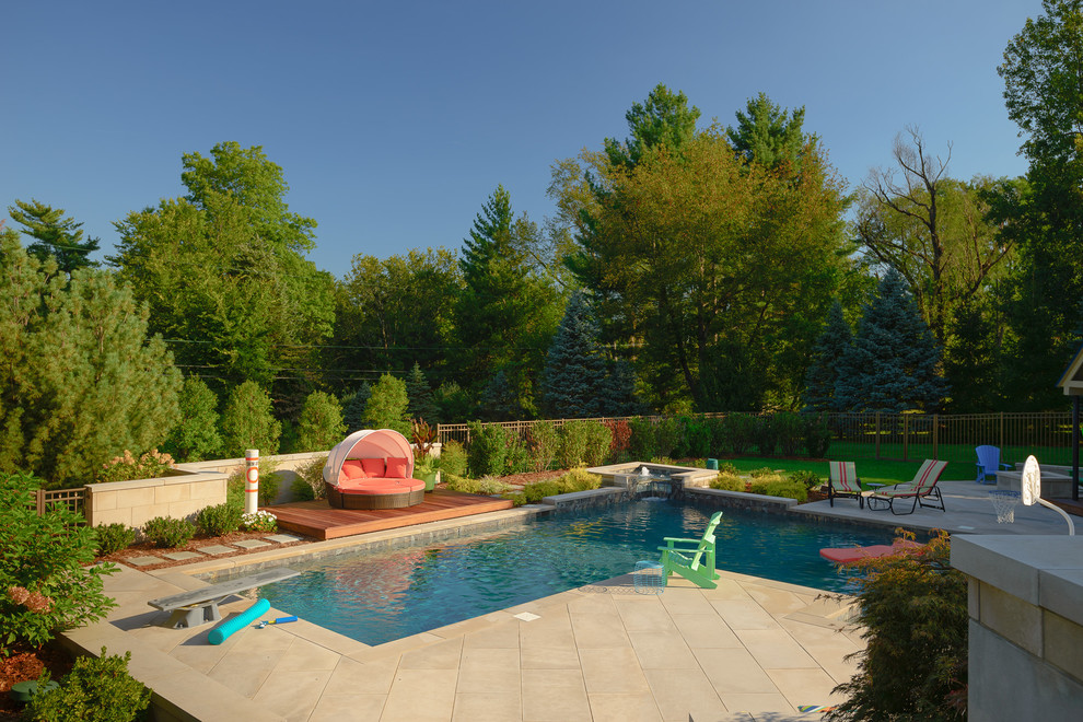 Inspiration for a mid-sized contemporary backyard l-shaped pool in Louisville with natural stone pavers.
