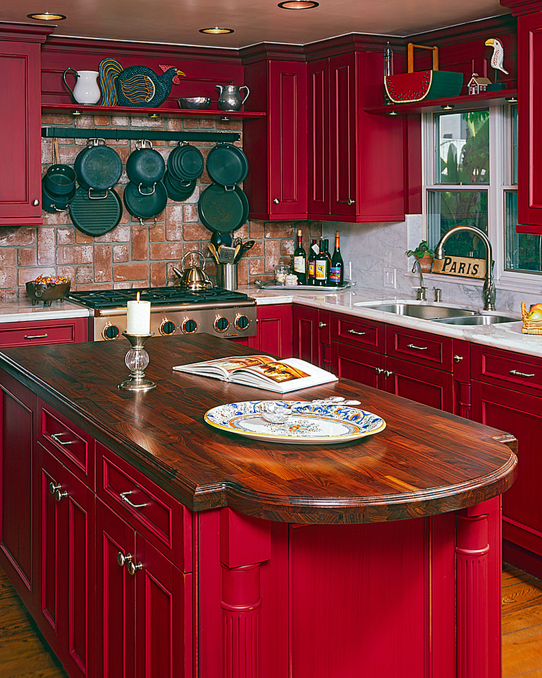 Mountain style light wood floor kitchen photo in Orange County with recessed-panel cabinets, red cabinets, marble countertops, stone slab backsplash and an island