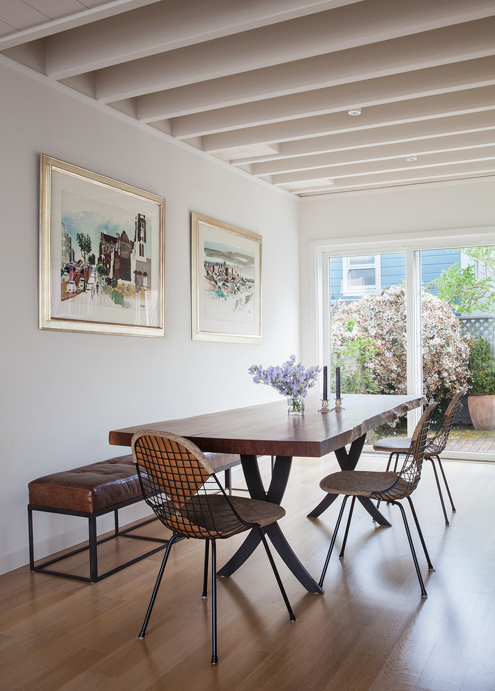 Inspiration for a midcentury dining room in San Francisco with white walls and light hardwood floors.