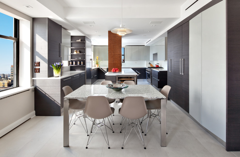 This is an example of a contemporary u-shaped eat-in kitchen in New York with flat-panel cabinets, dark wood cabinets, stainless steel appliances and with island.