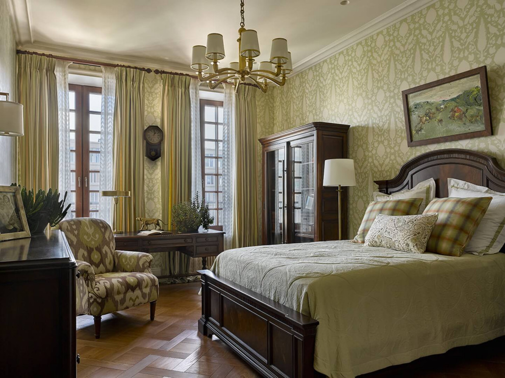 Design ideas for a mid-sized traditional master bedroom in Moscow with green walls, medium hardwood floors, no fireplace, brown floor and wallpaper.