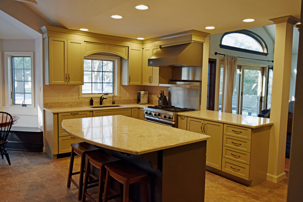 Kitchen - transitional kitchen idea with recessed-panel cabinets, quartz countertops and an island