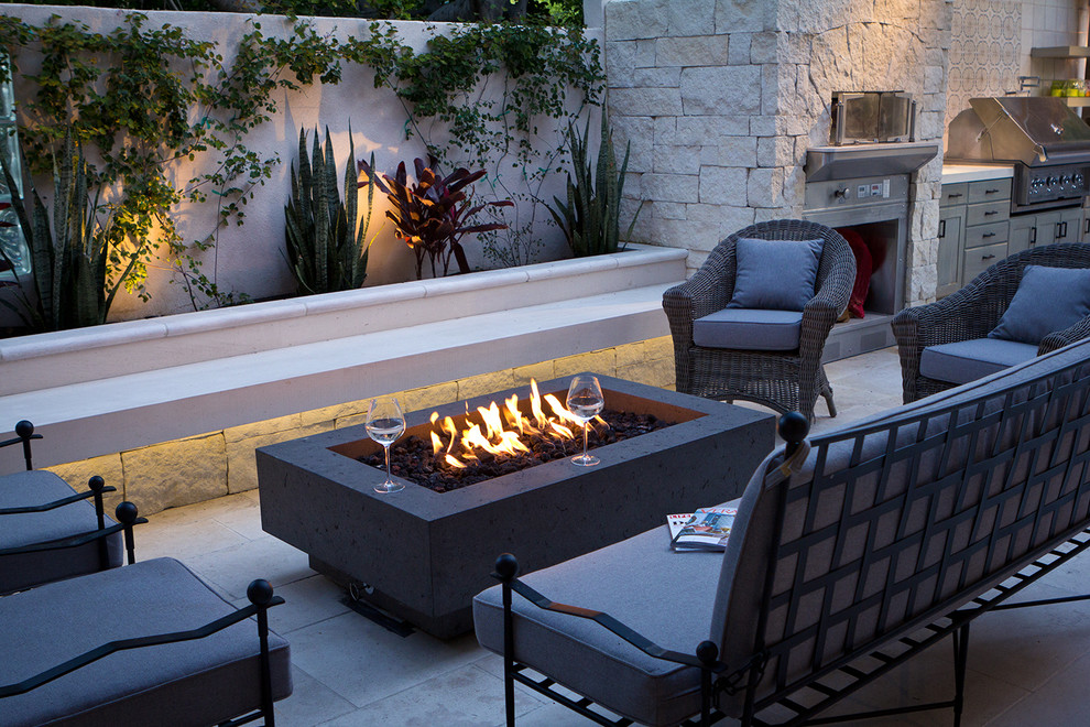 Photo of a large mediterranean backyard patio in Los Angeles with a fire feature.
