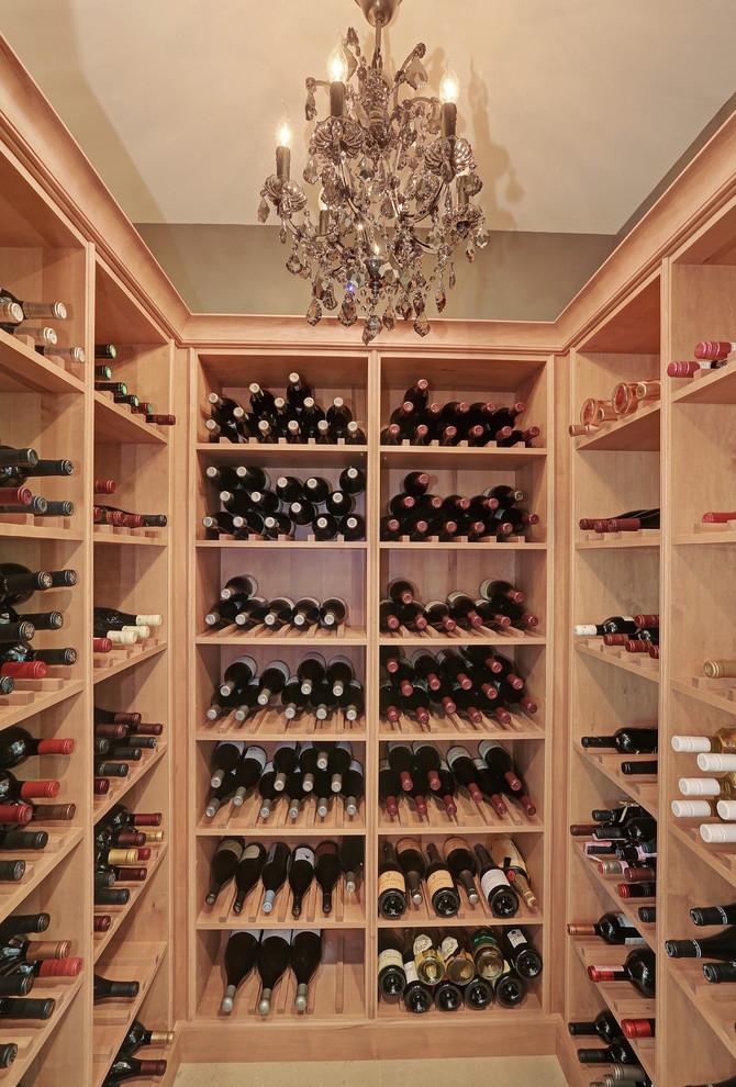 Small traditional wine cellar in Chicago with light hardwood floors and storage racks.