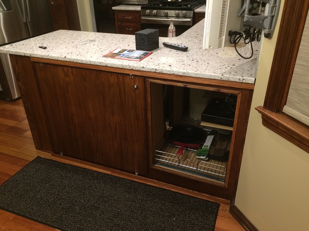 Inspiration for a mid-sized transitional u-shaped medium tone wood floor eat-in kitchen remodel with an undermount sink, recessed-panel cabinets, medium tone wood cabinets, quartz countertops, brown backsplash, glass tile backsplash, stainless steel appliances and a peninsula