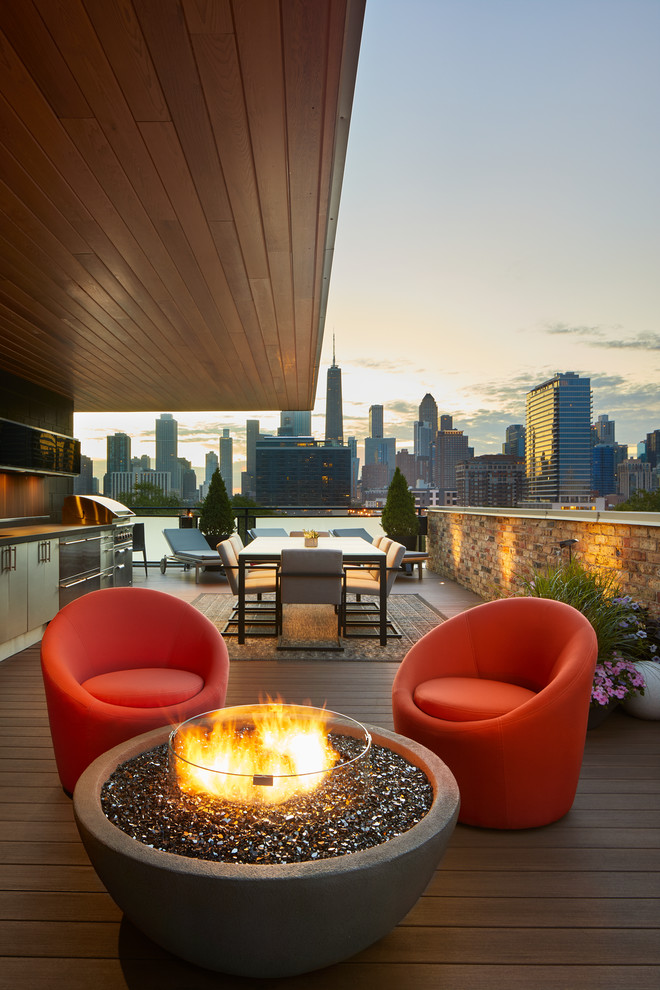 Design ideas for a mid-sized contemporary rooftop and rooftop deck in Chicago with a fire feature and an awning.