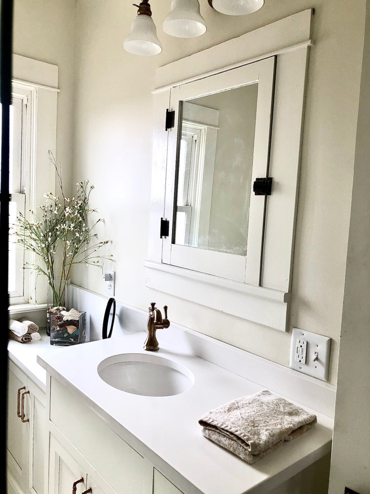 Inspiration for a small country 3/4 bathroom in Cedar Rapids with beaded inset cabinets, white cabinets, a corner shower, a two-piece toilet, white tile, cement tiles, an undermount sink, engineered quartz benchtops, white floor, a sliding shower screen, white benchtops, a single vanity and a built-in vanity.