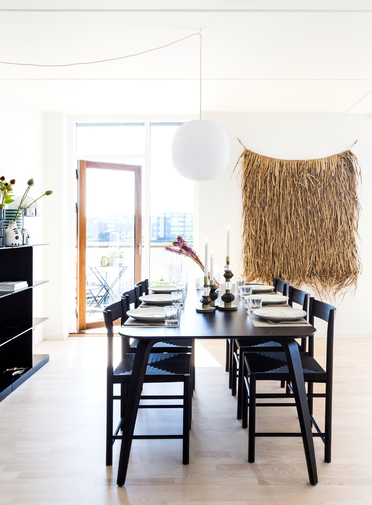 Design ideas for a mid-sized scandinavian kitchen/dining combo in Copenhagen with white walls, light hardwood floors and beige floor.