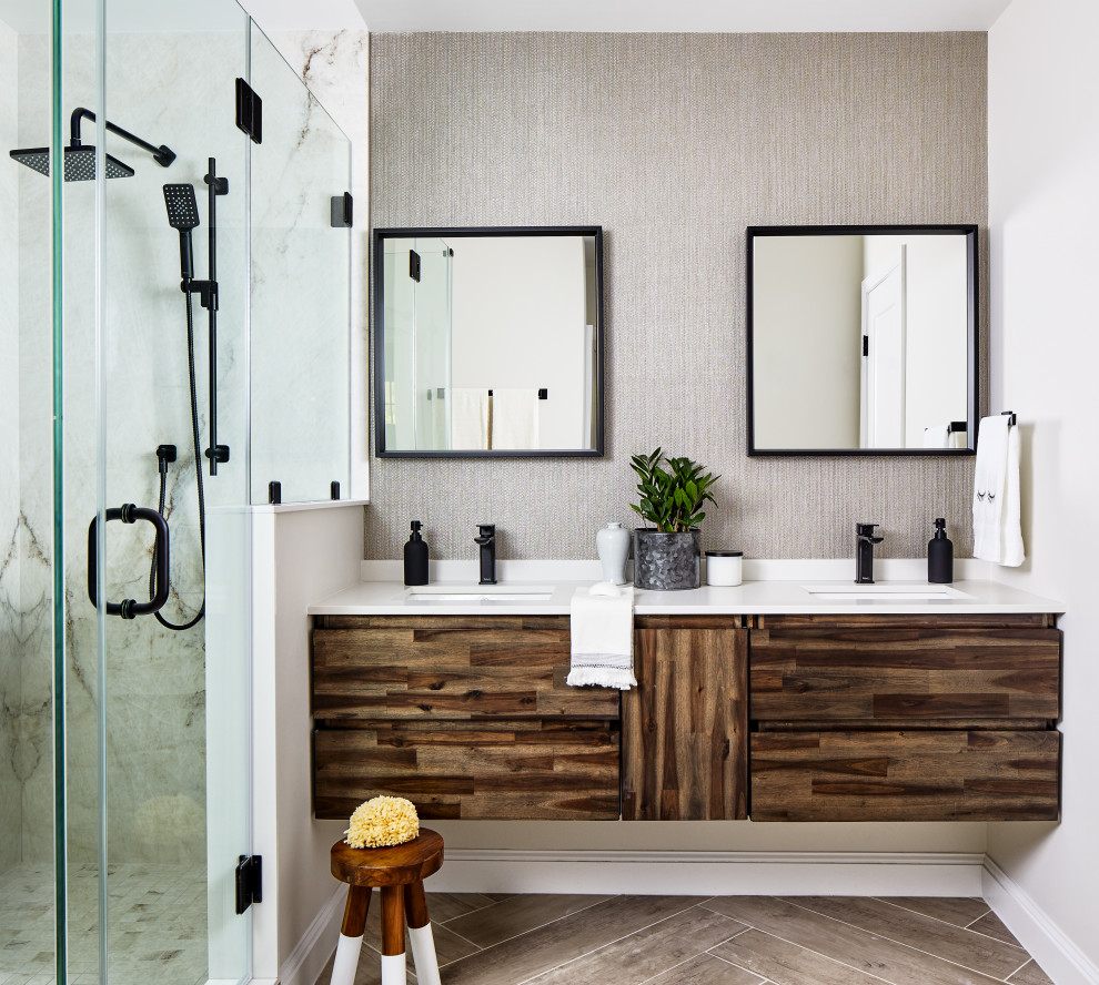 This is an example of a mid-sized contemporary master bathroom in DC Metro with flat-panel cabinets, dark wood cabinets, an alcove shower, gray tile, limestone, grey walls, porcelain floors, an undermount sink, engineered quartz benchtops, grey floor, a hinged shower door, white benchtops, a double vanity and a floating vanity.