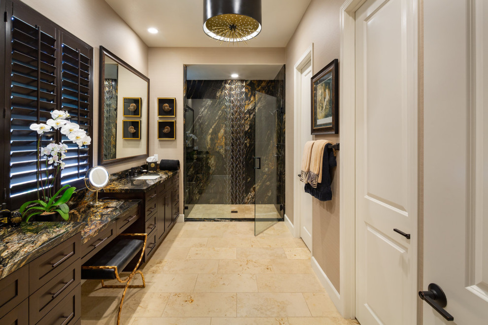 Large contemporary master bathroom in Orange County with shaker cabinets, dark wood cabinets, a curbless shower, a two-piece toilet, multi-coloured tile, stone slab, beige walls, limestone floors, an undermount sink, granite benchtops, a hinged shower door and multi-coloured benchtops.