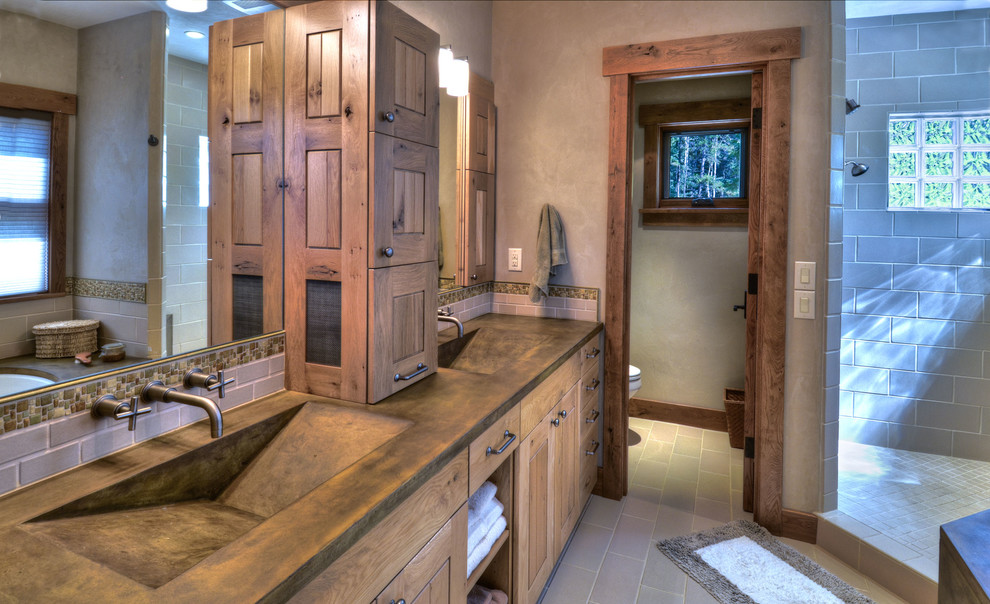 Photo of a large contemporary master bathroom in Denver with flat-panel cabinets, light wood cabinets, a corner shower, beige walls, an integrated sink, concrete benchtops, gray tile, subway tile, porcelain floors and brown floor.