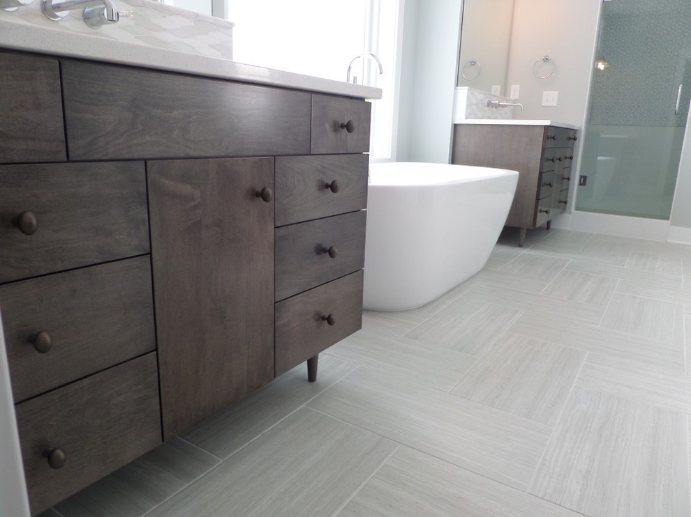Design ideas for a large arts and crafts master bathroom in Grand Rapids with flat-panel cabinets, dark wood cabinets, a freestanding tub, a corner shower, white tile, white walls, porcelain floors and a console sink.
