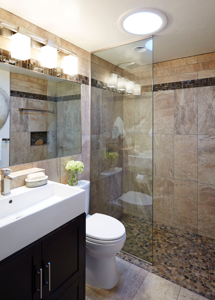 Small midcentury 3/4 bathroom in San Francisco with a console sink, recessed-panel cabinets, black cabinets, solid surface benchtops, an alcove shower, a one-piece toilet, white tile, stone tile, beige walls and travertine floors.