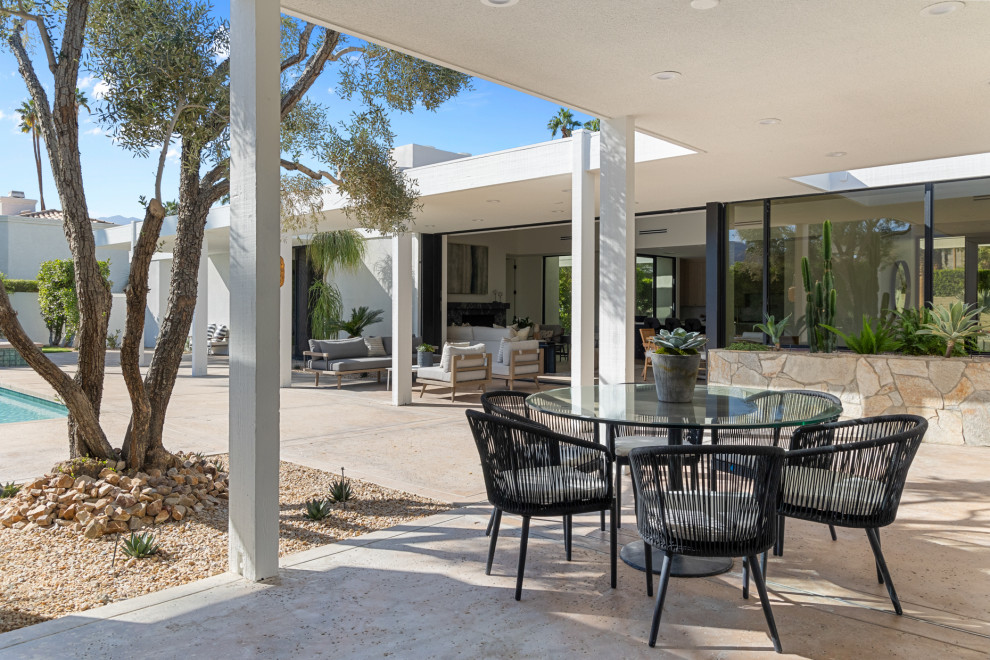 Patio - large transitional backyard concrete patio idea with a roof extension
