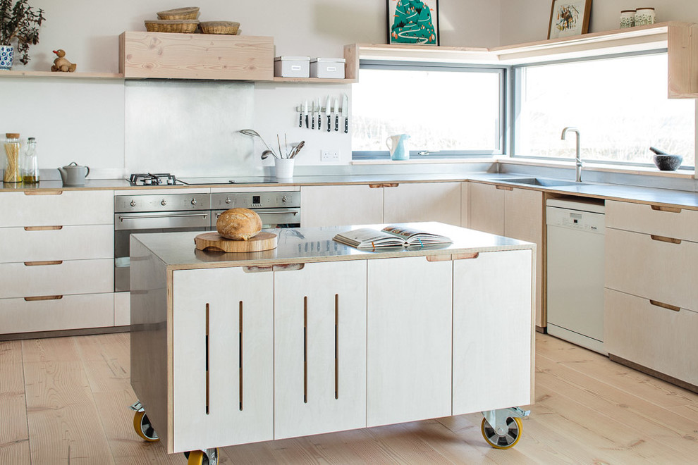 This is an example of a mid-sized scandinavian l-shaped eat-in kitchen in Other with a farmhouse sink, flat-panel cabinets, stainless steel benchtops, metallic splashback, stainless steel appliances, light hardwood floors, with island and white cabinets.