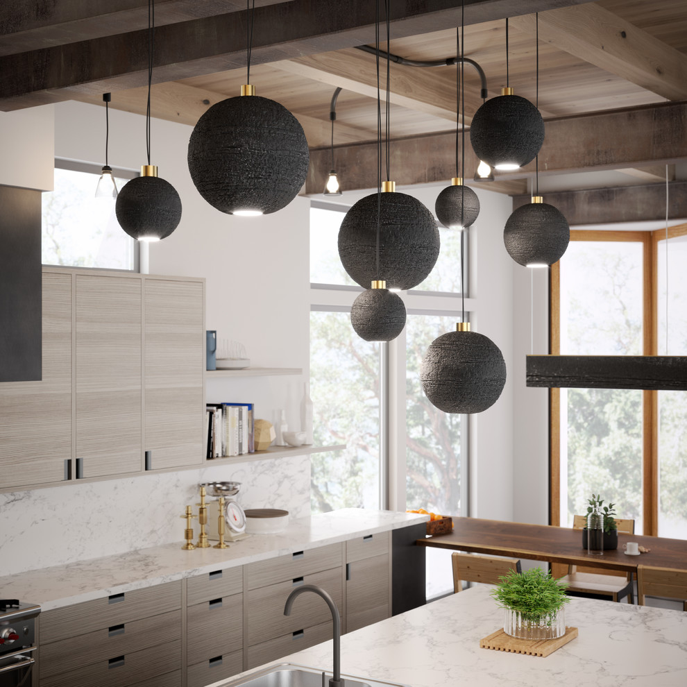 This is an example of a large contemporary u-shaped open plan kitchen in Seattle with flat-panel cabinets, light wood cabinets, marble benchtops, white splashback, stone slab splashback, concrete floors and with island.