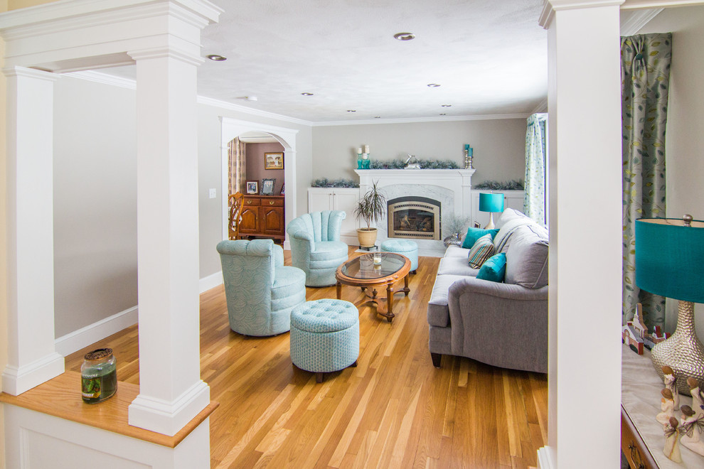 Mid-sized traditional formal enclosed living room in Boston with grey walls, medium hardwood floors, a standard fireplace, a stone fireplace surround and no tv.