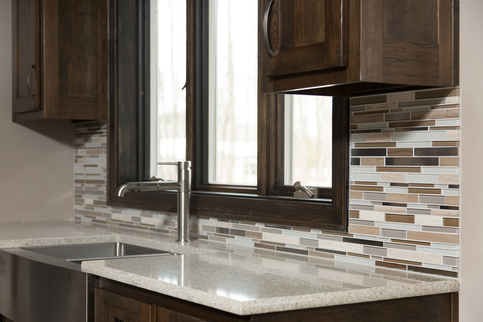 Inspiration for a mid-sized transitional l-shaped vinyl floor eat-in kitchen remodel with stainless steel appliances, a farmhouse sink, shaker cabinets, dark wood cabinets, quartz countertops, multicolored backsplash, matchstick tile backsplash and an island