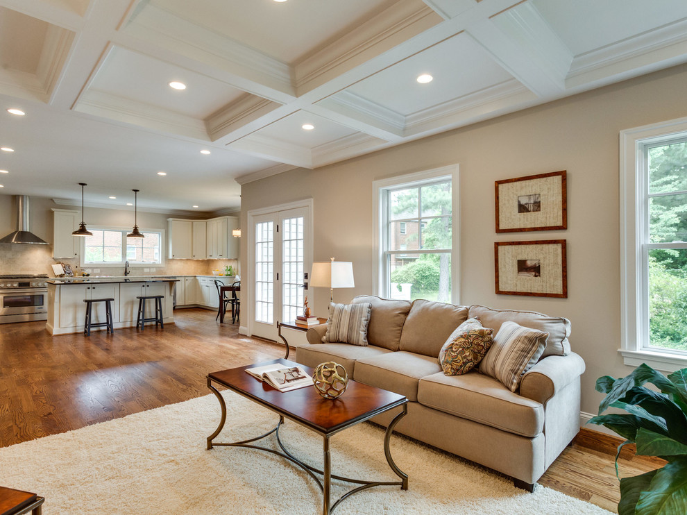Inspiration for a traditional open concept living room in DC Metro with beige walls and light hardwood floors.