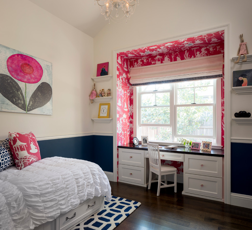 This is an example of a traditional kids' bedroom for kids 4-10 years old and girls in San Francisco with white walls and dark hardwood floors.