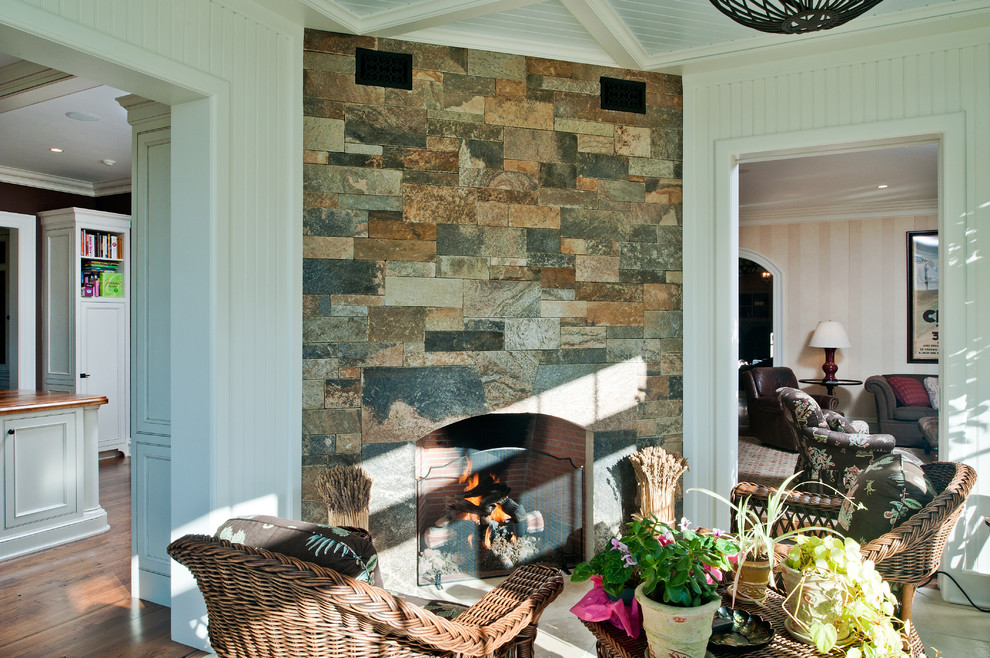 Inspiration for a mid-sized traditional sunroom in New York with limestone floors, a corner fireplace, a stone fireplace surround and a standard ceiling.