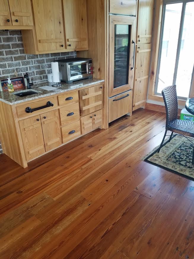 Eat-in kitchen - small rustic single-wall dark wood floor and brown floor eat-in kitchen idea in Atlanta with an undermount sink, flat-panel cabinets, light wood cabinets, granite countertops, brown backsplash, brick backsplash, paneled appliances, no island and multicolored countertops