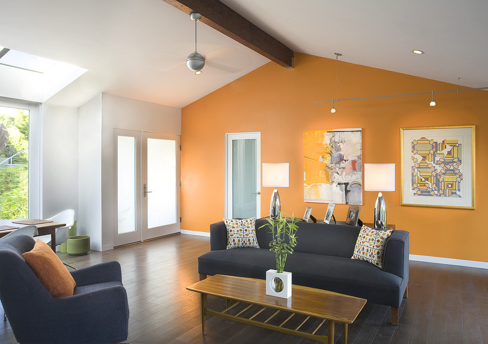 Design ideas for a mid-sized contemporary open concept living room in Santa Barbara with orange walls and dark hardwood floors.