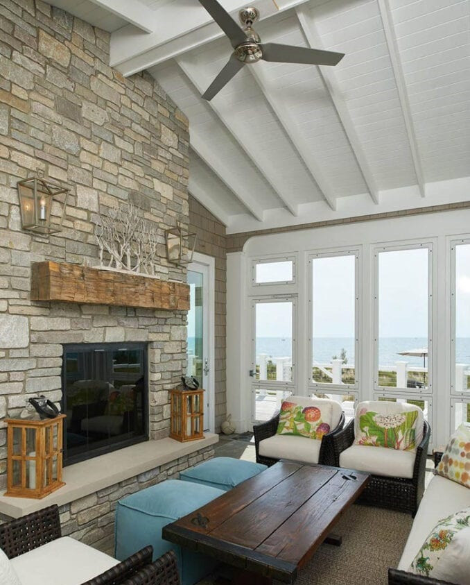 Inspiration for a coastal open plan living room in Other with white walls, a standard fireplace, a stone fireplace surround, no tv and a vaulted ceiling.