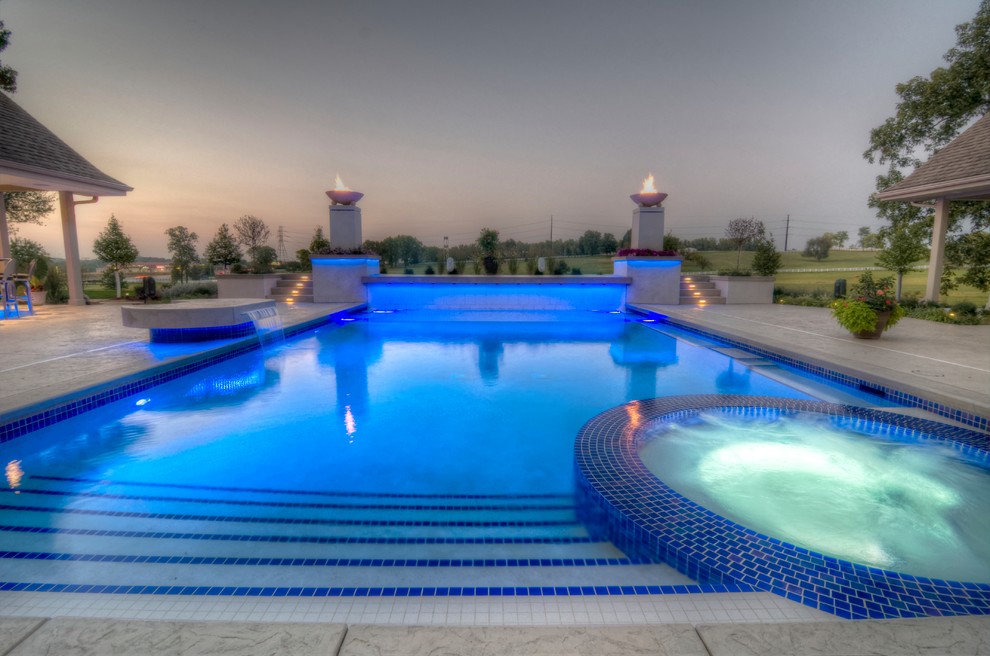 Large transitional backyard concrete paver and rectangular natural hot tub photo in Cedar Rapids
