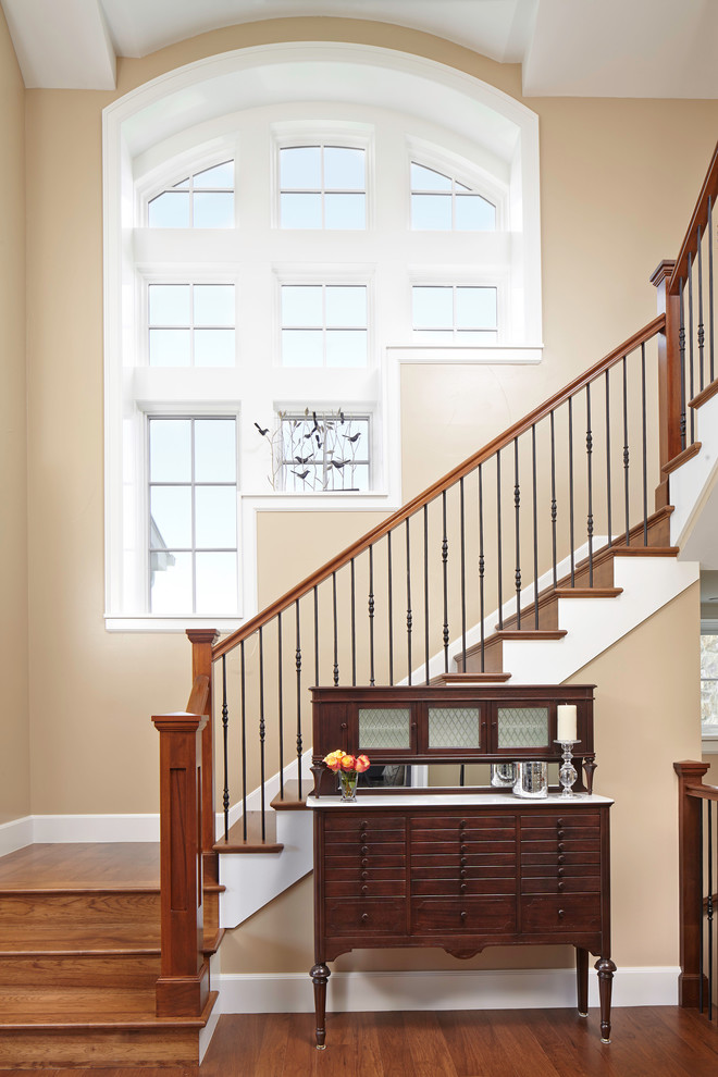 Photo of a traditional wood l-shaped staircase in Denver with wood risers.